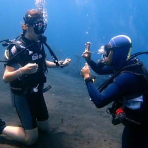Diving instructor with his student in the open water
